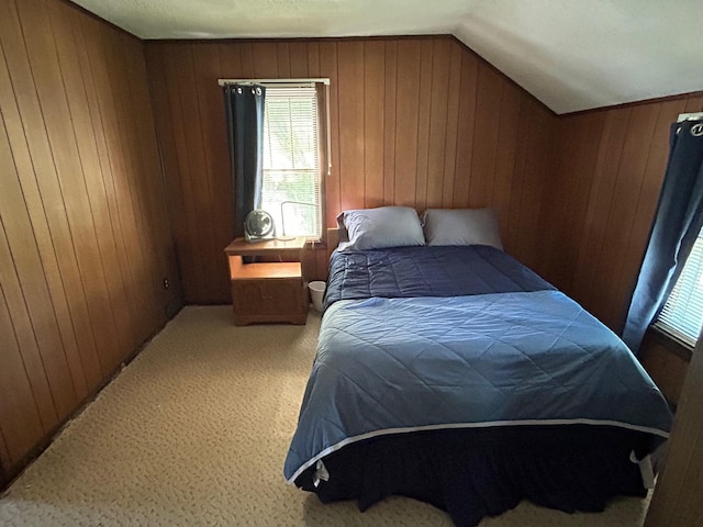 823 5th St, Grand Rapids, MN 55744 - bedroom featuring multiple windows, wooden walls, light carpet, and vaulted ceiling