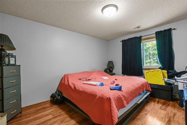 8972 Trista Ln, Saint Bonifacius, MN 55375 - bedroom featuring wood finished floors and a textured ceiling