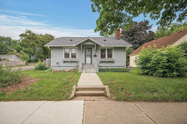 4301 Columbus Ave, Minneapolis, MN 55407 - bungalow-style house featuring a front lawn, a chimney, and roof with shingles