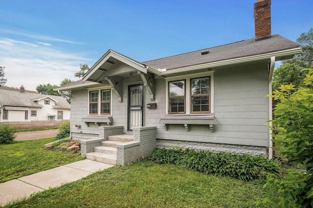 4301 Columbus Ave, Minneapolis, MN 55407 - view of front of property with a chimney and a front lawn