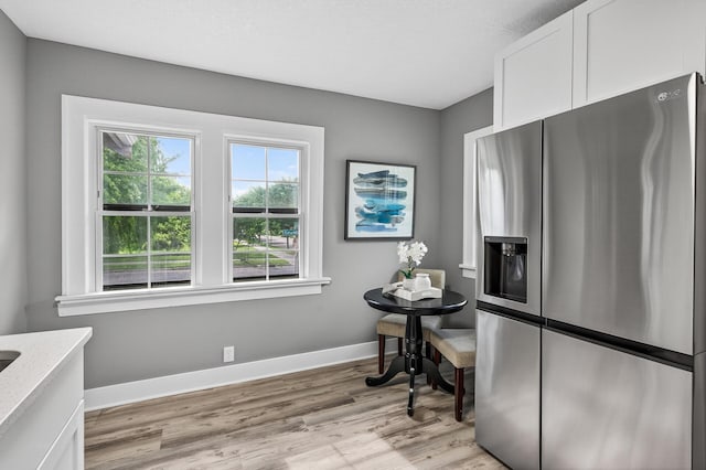 4301 Columbus Ave, Minneapolis, MN 55407 - dining room featuring light wood-type flooring and baseboards