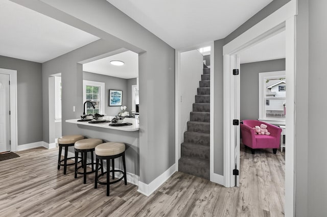 4301 Columbus Ave, Minneapolis, MN 55407 - kitchen with wood finished floors, a breakfast bar area, and light countertops
