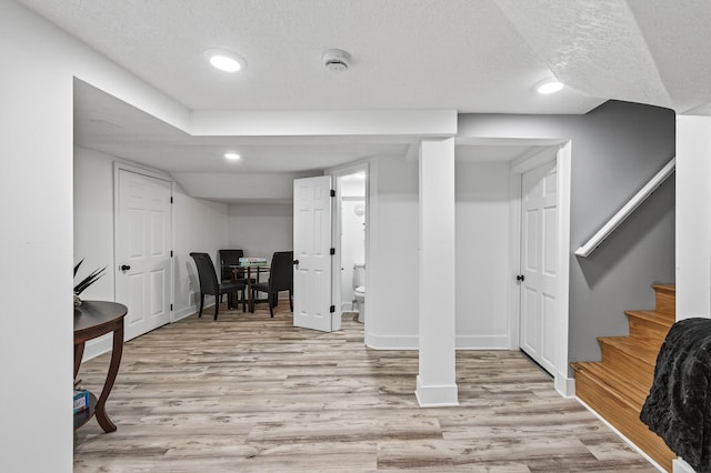 4301 Columbus Ave, Minneapolis, MN 55407 - finished below grade area featuring a textured ceiling, light wood-style floors, recessed lighting, and stairway