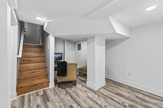 4301 Columbus Ave, Minneapolis, MN 55407 - finished basement with wood finished floors, stairway, and a textured ceiling