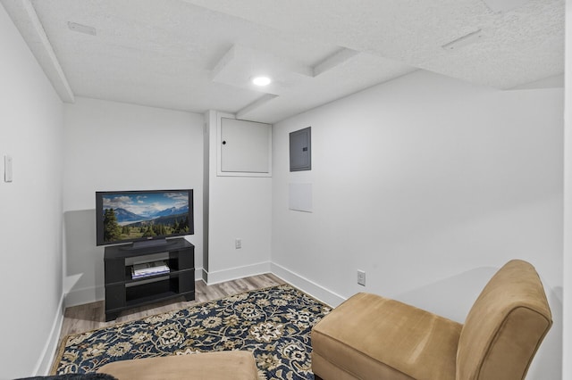 4301 Columbus Ave, Minneapolis, MN 55407 - sitting room featuring wood finished floors, electric panel, a textured ceiling, and recessed lighting
