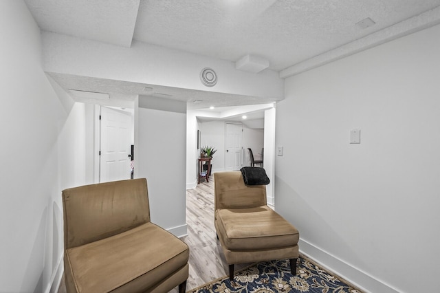 4301 Columbus Ave, Minneapolis, MN 55407 - sitting room featuring a textured ceiling and light wood-type flooring