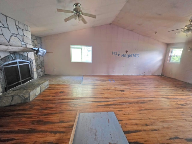 2001 Shilhon Rd, Duluth, MN 55804 - unfurnished living room with ceiling fan, hardwood / wood-style flooring, vaulted ceiling, and a fireplace