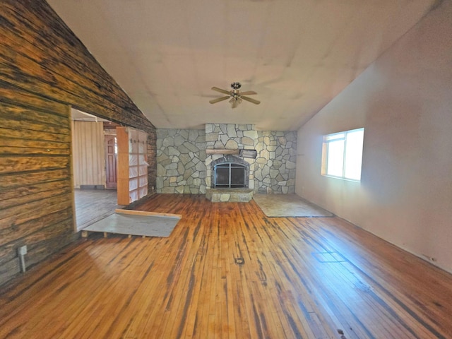 2001 Shilhon Rd, Duluth, MN 55804 - unfurnished living room with hardwood / wood-style flooring, ceiling fan, lofted ceiling, and a stone fireplace