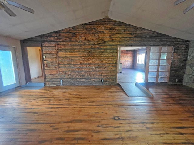 2001 Shilhon Rd, Duluth, MN 55804 - unfurnished living room featuring lofted ceiling, a ceiling fan, hardwood / wood-style floors, and wood walls