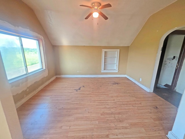 2001 Shilhon Rd, Duluth, MN 55804 - unfurnished room with lofted ceiling, a ceiling fan, arched walkways, light wood finished floors, and built in features