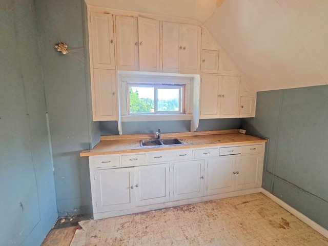 2001 Shilhon Rd, Duluth, MN 55804 - kitchen featuring vaulted ceiling, light countertops, and white cabinets