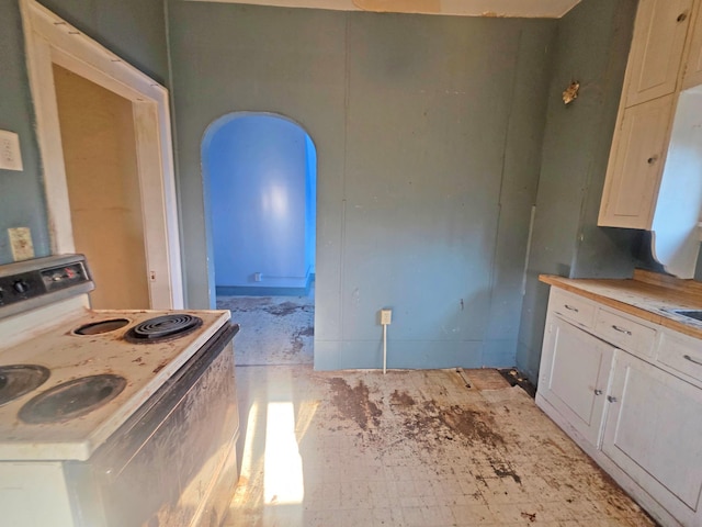 2001 Shilhon Rd, Duluth, MN 55804 - kitchen with electric range oven, light countertops, and white cabinets