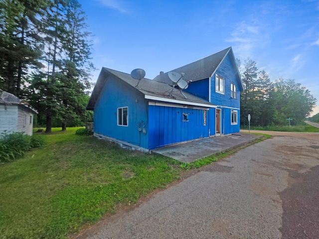 2001 Shilhon Rd, Duluth, MN 55804 - view of side of home featuring a lawn and board and batten siding