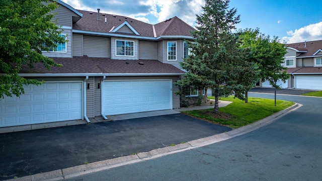 5607 100th Ln N, Brooklyn Park, MN 55443 - townhome / multi-family property featuring asphalt driveway, roof with shingles, and a garage