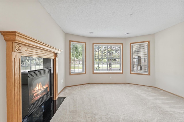 5607 100th Ln N, Brooklyn Park, MN 55443 - unfurnished living room featuring a tiled fireplace, carpet floors, and a textured ceiling