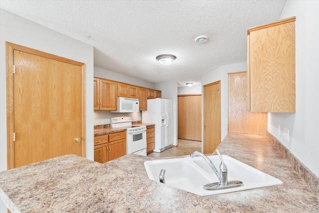 5607 100th Ln N, Brooklyn Park, MN 55443 - kitchen featuring white appliances, light countertops, a textured ceiling, and a peninsula