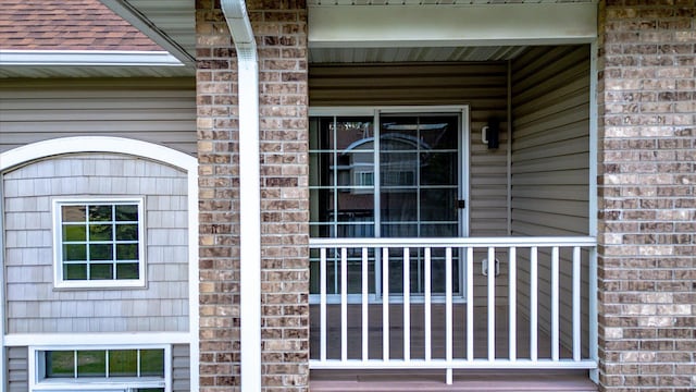 5607 100th Ln N, Brooklyn Park, MN 55443 - doorway to property featuring brick siding and covered porch