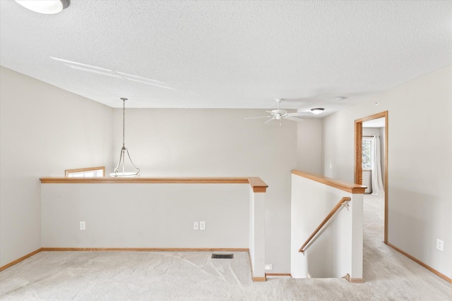 5607 100th Ln N, Brooklyn Park, MN 55443 - spare room with a textured ceiling, a ceiling fan, and carpet floors