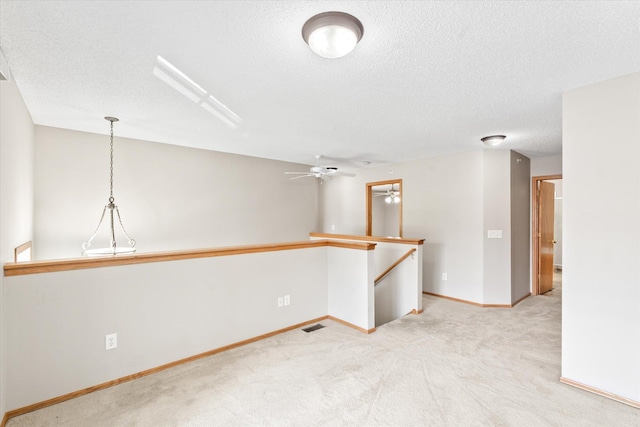5607 100th Ln N, Brooklyn Park, MN 55443 - spare room featuring a textured ceiling, a ceiling fan, and light colored carpet