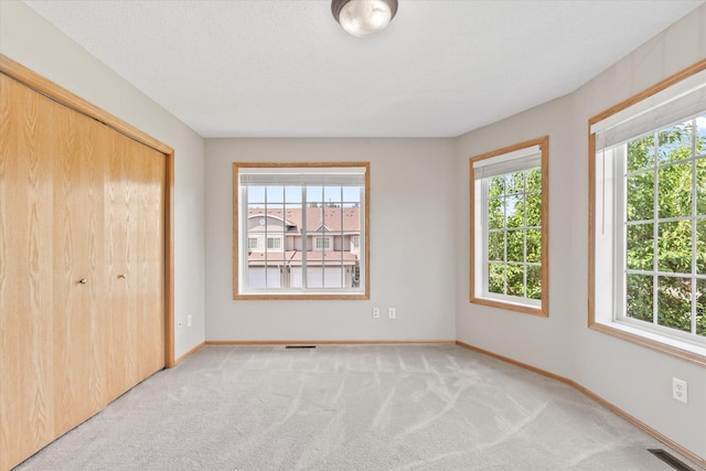 5607 100th Ln N, Brooklyn Park, MN 55443 - unfurnished bedroom featuring light carpet and a closet