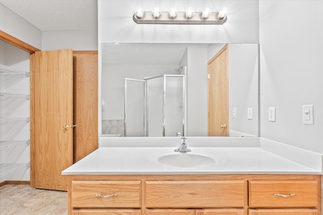 5607 100th Ln N, Brooklyn Park, MN 55443 - full bathroom featuring vanity, a shower stall, and a textured ceiling