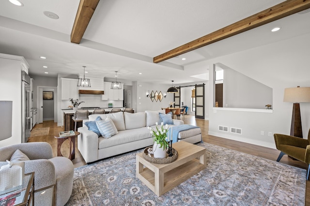 16830 59th Ave N, Plymouth, MN 55446 - living area featuring a barn door, recessed lighting, light wood-style floors, and beamed ceiling