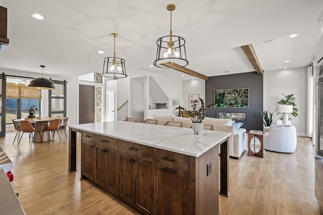 16830 59th Ave N, Plymouth, MN 55446 - kitchen featuring beamed ceiling, light wood-style floors, healthy amount of natural light, open floor plan, and pendant lighting