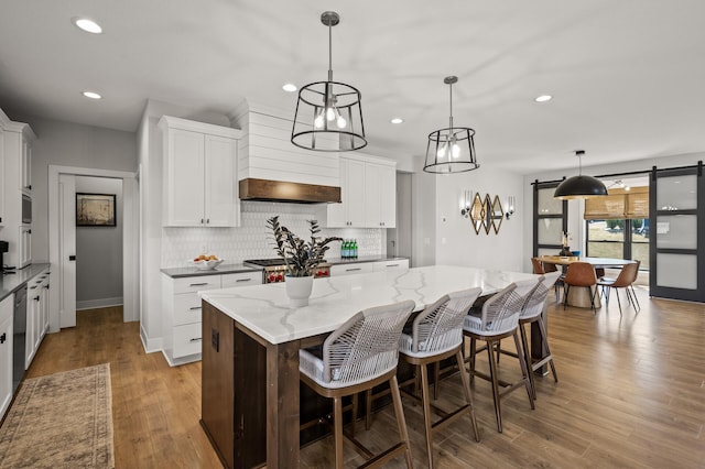 16830 59th Ave N, Plymouth, MN 55446 - kitchen with recessed lighting, decorative backsplash, white cabinetry, premium range hood, and a center island