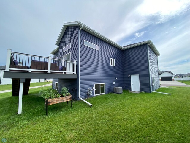 1819 67th Ave S, Fargo, ND 58104 - rear view of house featuring a yard and a deck