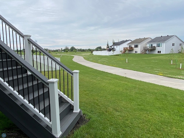1819 67th Ave S, Fargo, ND 58104 - view of grassy yard with stairs and a residential view