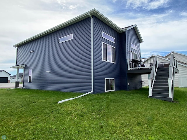 1819 67th Ave S, Fargo, ND 58104 - view of side of home with stairway, a deck, and a lawn