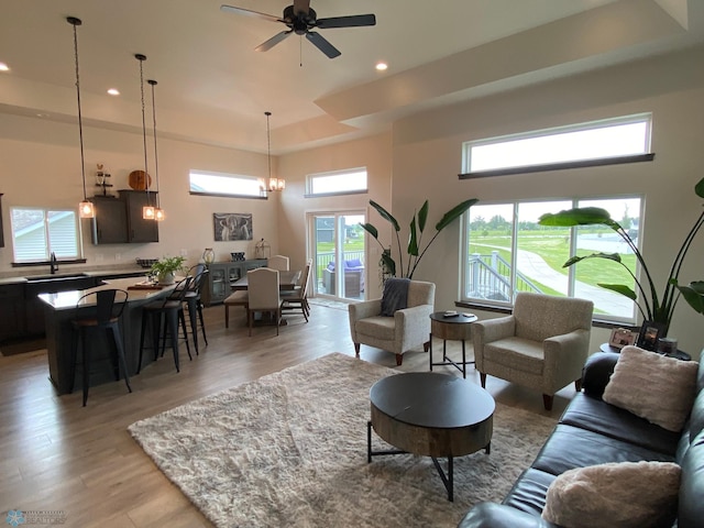 1819 67th Ave S, Fargo, ND 58104 - living area with recessed lighting, light wood-style floors, plenty of natural light, a ceiling fan, and a chandelier