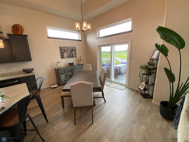 1819 67th Ave S, Fargo, ND 58104 - dining area featuring a chandelier, light wood-style flooring, and a high ceiling
