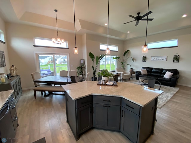 1819 67th Ave S, Fargo, ND 58104 - kitchen featuring a tray ceiling, light wood-style floors, a ceiling fan, and recessed lighting
