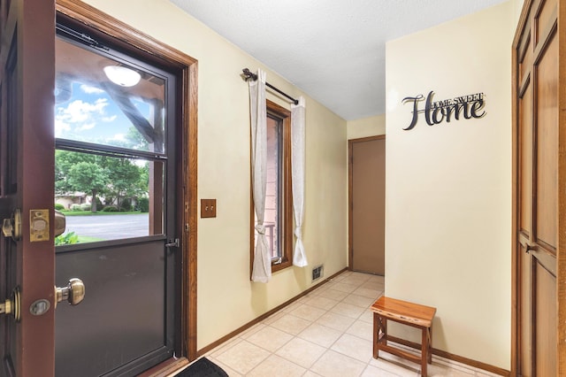 2539 83rd Ct N, Brooklyn Park, MN 55444 - foyer with light tile patterned flooring and baseboards