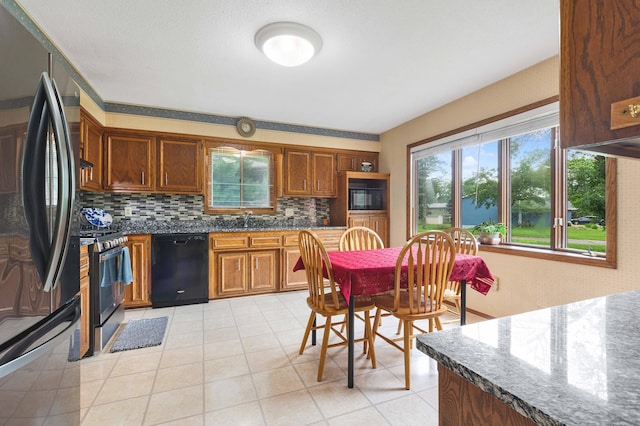 2539 83rd Ct N, Brooklyn Park, MN 55444 - kitchen featuring black appliances, backsplash, plenty of natural light, and light tile patterned flooring