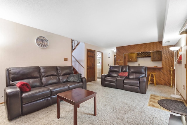 2539 83rd Ct N, Brooklyn Park, MN 55444 - living area with light colored carpet, stairway, wooden walls, and an accent wall
