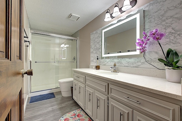 2539 83rd Ct N, Brooklyn Park, MN 55444 - full bath with vanity, a stall shower, wood finished floors, and decorative backsplash