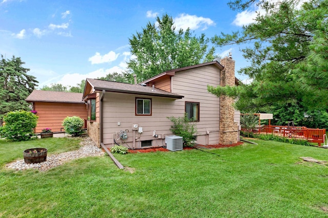 2539 83rd Ct N, Brooklyn Park, MN 55444 - back of property with a chimney, a yard, an outdoor fire pit, and a wooden deck