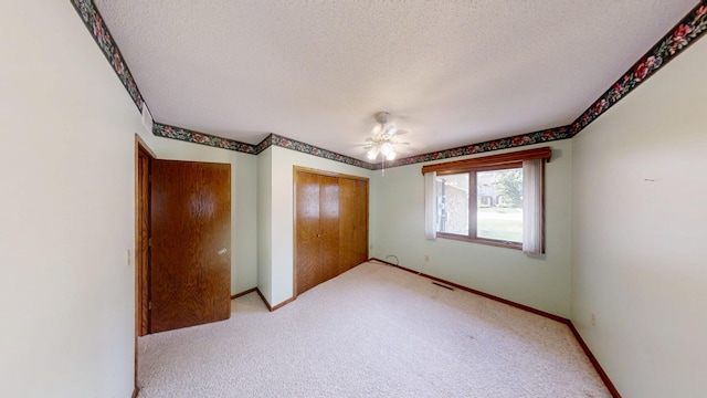 1930 Wilby Rd, Albert Lea, MN 56007 - unfurnished bedroom with a textured ceiling, a closet, light carpet, and ceiling fan