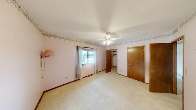 1930 Wilby Rd, Albert Lea, MN 56007 - unfurnished bedroom featuring ceiling fan, light colored carpet, and two closets