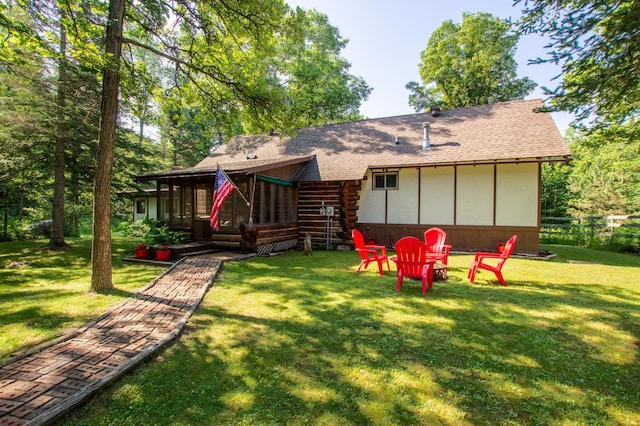 31759 County 30, Laporte, MN 56461 - rear view of property featuring a shingled roof, a sunroom, a lawn, and log exterior