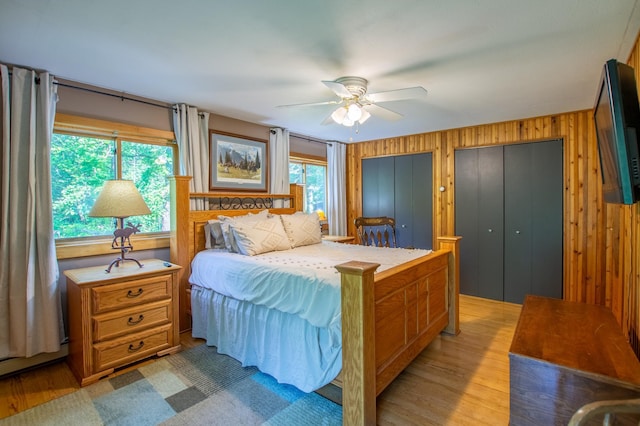 31759 County 30, Laporte, MN 56461 - bedroom with light wood-type flooring, wood walls, two closets, a ceiling fan, and baseboard heating
