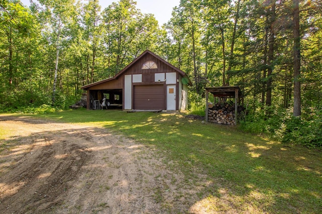 31759 County 30, Laporte, MN 56461 - view of front of house featuring a garage, dirt driveway, an outdoor structure, and a front lawn