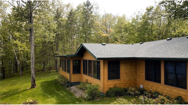 7310 Moose Lake Rd NE, Blackduck, MN 56630 - view of property exterior featuring roof with shingles and a lawn