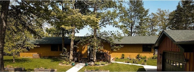 7310 Moose Lake Rd NE, Blackduck, MN 56630 - back of house with a lawn, roof with shingles, a garage, and driveway