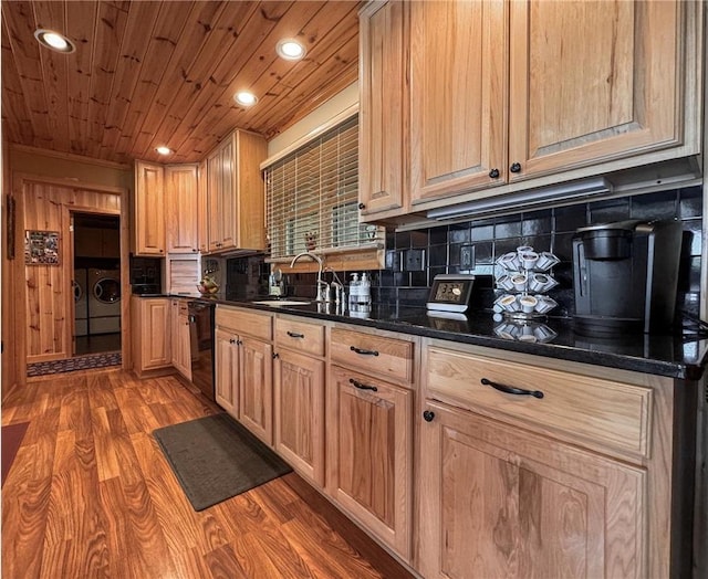 7310 Moose Lake Rd NE, Blackduck, MN 56630 - kitchen featuring washer and clothes dryer, dishwasher, light wood-style floors, dark countertops, and decorative backsplash