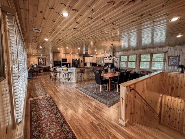 7310 Moose Lake Rd NE, Blackduck, MN 56630 - dining space with light wood-style flooring, wood ceiling, and recessed lighting