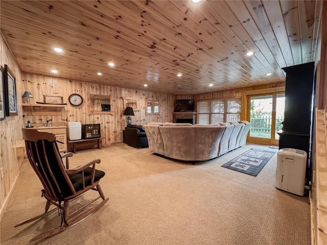 7310 Moose Lake Rd NE, Blackduck, MN 56630 - living area with light colored carpet, wood ceiling, recessed lighting, wooden walls, and a fireplace