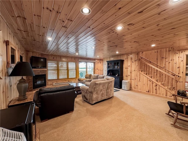 7310 Moose Lake Rd NE, Blackduck, MN 56630 - living room with wood walls, a glass covered fireplace, carpet flooring, stairway, and wooden ceiling